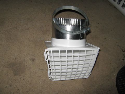2000 Mercury Grand Marquis - A white plastic dryer vent termination cap with a metal collar and clamp is shown on a concrete floor.