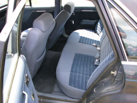 1985 Ford LTD - The interior of a 1985 Ford LTD features blue cloth seats and dark trim.