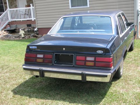 1985 Ford LTD - Rear view of a 1985 Ford LTD sedan, parked on a grassy lawn.