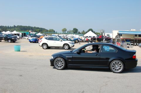 2002 BMW M3 - A black 2002 BMW M3 coupe is seen on a track with racing numbers displayed on its window.