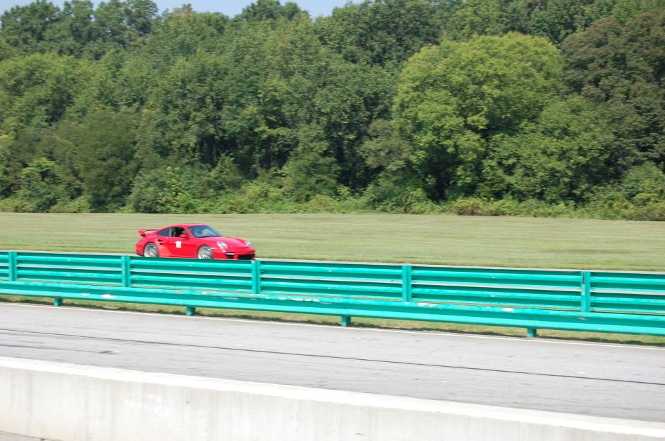 Red Porsche 911 on a race track, side view