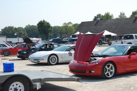 2002 BMW M3 - Cars are lined up at an outdoor event, with several hoods open, suggesting preparation or display.