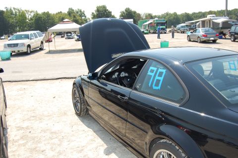 2002 BMW M3 - A black 2002 BMW M3 coupe is parked with its hood open, displaying blue racing numbers '98' on the side window.