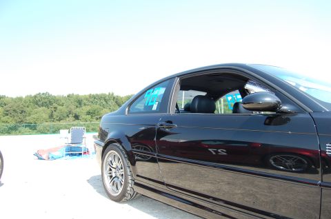 2002 BMW M3 - Side profile of a black 2002 BMW M3 coupe on a sunny day.