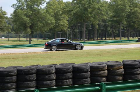 2002 BMW M3 - A black 2002 BMW M3 coupe is seen on a racetrack, likely during a track day event.