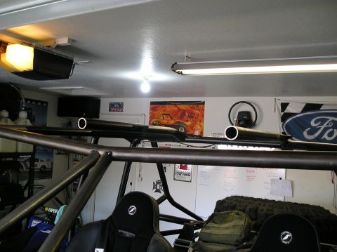 1986 Toyota Hilux - Interior view of a custom off-road vehicle with a prominent roll cage and racing seat.