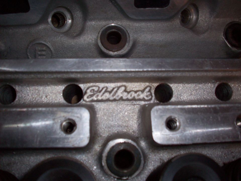 Close-up of an aluminum engine cylinder head with 'Edelbrock' cast into it