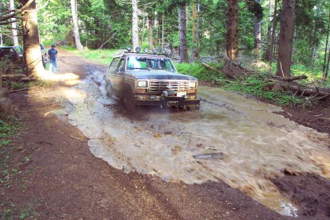 1989 Ford F-150 - Ken digging his way through the mud hole. He was the only one to conquer the mud hole.Anne K. and myself finessed our way around the left s…