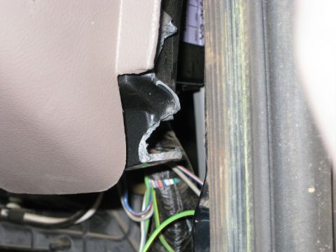 1995 Ford Bronco - Close-up view of the interior of a vehicle, showing exposed wiring and paneling.