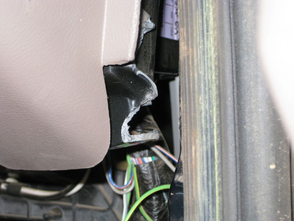 Tan interior paneling and exposed wiring loom inside a vehicle