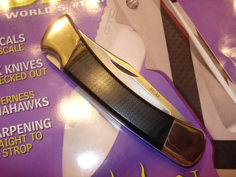 2000 Ford Crown Victoria - Buck BG-42 knife shown on a magazine cover with text about knives.
