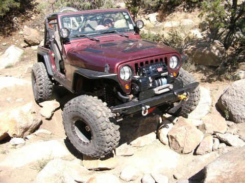 1995 Ford Bronco - This modified Jeep Wrangler TJ navigates a challenging rocky trail.