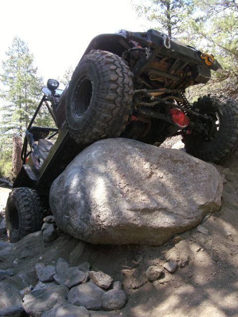 1995 Ford Bronco - Modified off-road vehicle navigating a difficult rocky terrain.