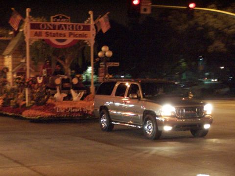 1990 Ford Bronco - This GMC Yukon XL is seen at night, possibly during a parade, with a decorated float in the background.