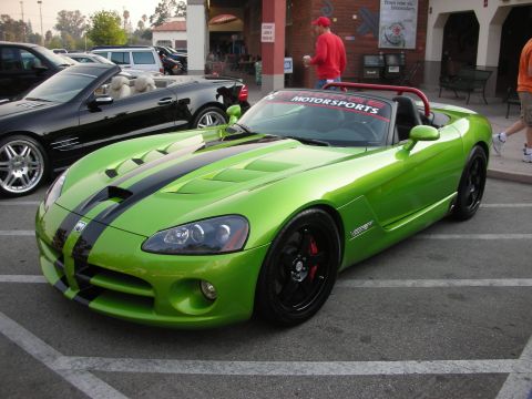 1998 Ford Crown Victoria - Lime green Dodge Viper convertible parked in a lot, with a black convertible behind it.