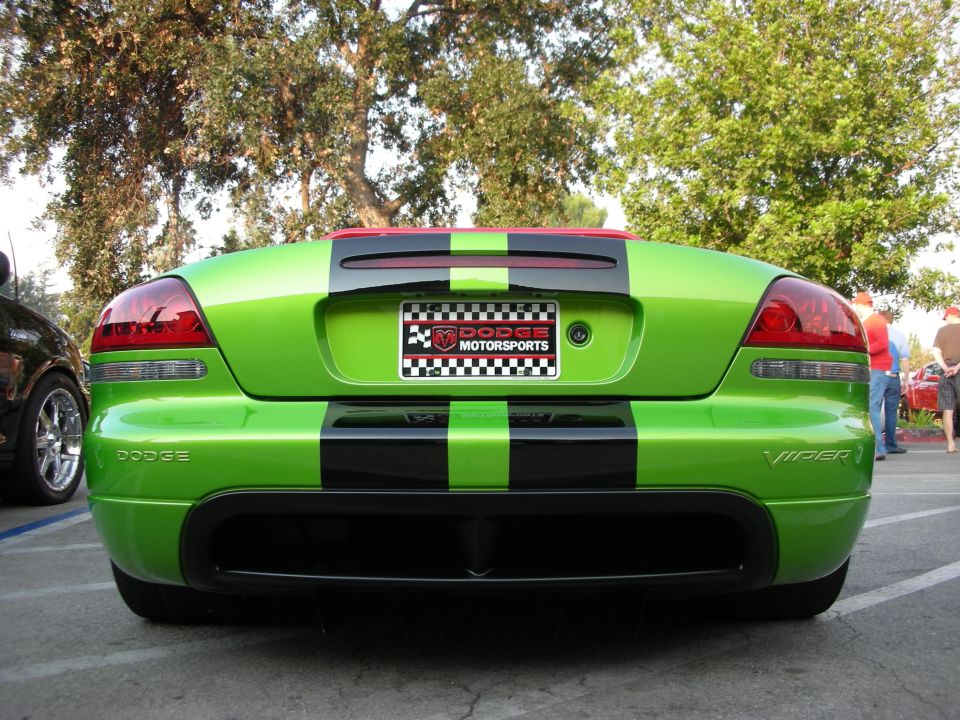 Green Dodge Viper with black racing stripes, rear view. Dodge Motorsports license plate frame