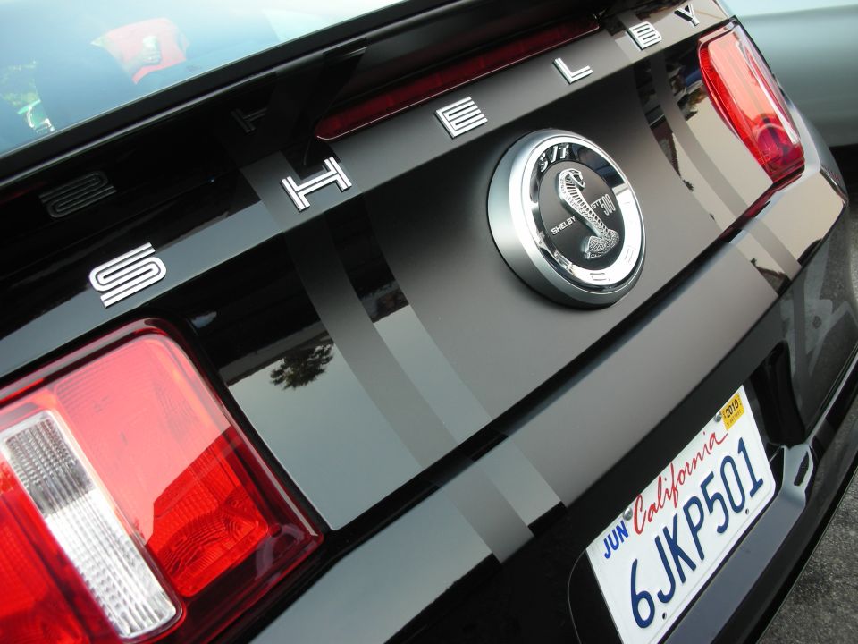 Black Shelby GT500 rear with racing stripes and cobra emblem