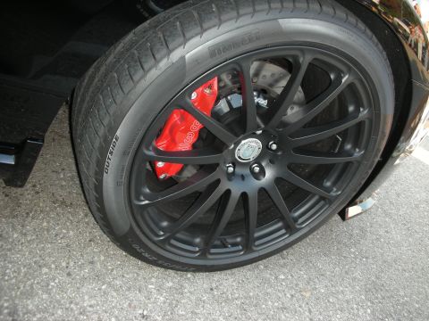 1998 Ford Crown Victoria - A close-up view of a car's wheel, its performance brake system and tire details.