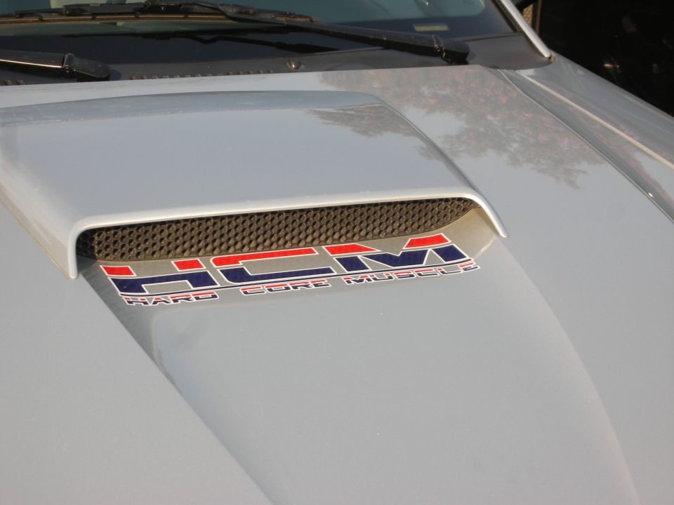 Silver hood scoop with "HCM HARD CORE MUSCLES" decal