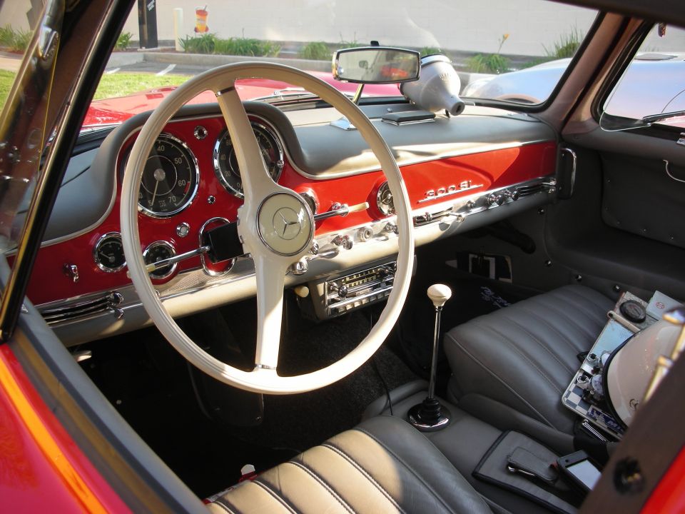Red interior with white steering wheel and dashboard, "300 SL" badging visible