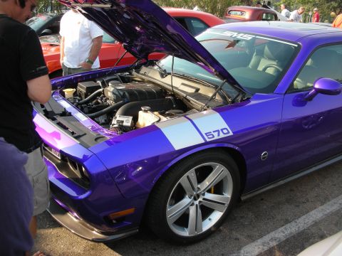 1998 Ford Crown Victoria - A purple Dodge Challenger is displayed with its hood open, revealing the engine compartment and a prominent '570' decal.