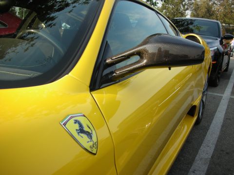 1998 Ford Crown Victoria - A yellow sports car is parked next to another vehicle.
