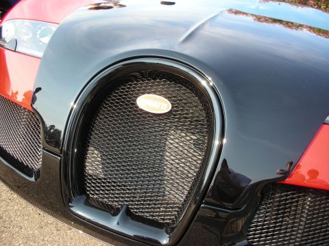 1998 Ford Crown Victoria - The iconic horseshoe grille of a Bugatti Veyron is visible, the brand's oval emblem.
