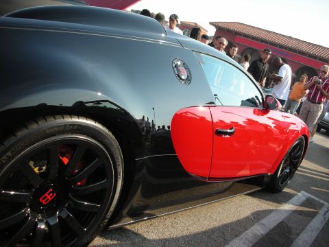 1998 Ford Crown Victoria - Bugatti Veyron's distinctive two-tone paint scheme is visible at a car meet.