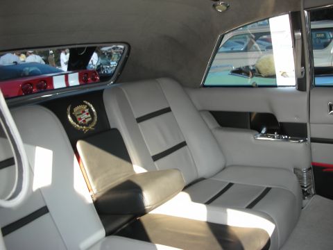 1998 Ford Crown Victoria - Interior view of a car showing custom seating and reflections of other vehicles in the rear window.