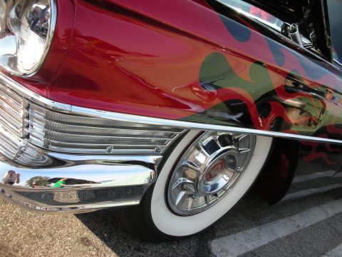 1998 Ford Crown Victoria - Classic red car with flame graphics and whitewall tires, seen at a coffee meet.