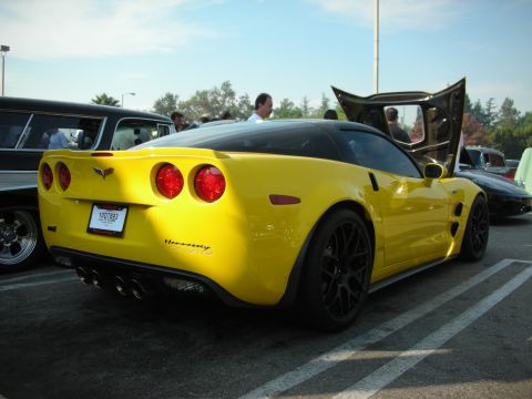 1998 Ford Crown Victoria - Yellow Chevrolet Corvette parked at an event, hood open. Hennessey badging is visible on the rear.
