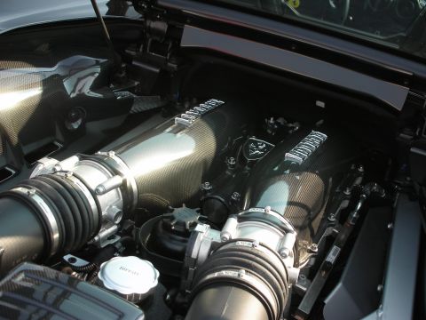 1998 Ford Crown Victoria - Close-up of a high-performance engine bay, carbon fiber components and a Ferrari emblem.