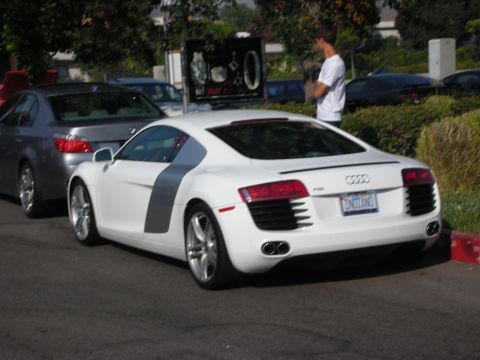 1998 Ford Crown Victoria - A white Audi R8 is parked on the street next to a gray BMW sedan.