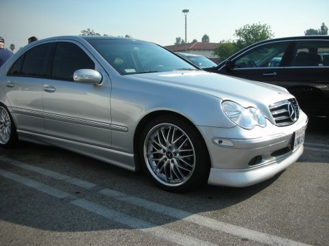 1998 Ford Crown Victoria - A silver Mercedes-Benz sedan is parked in a lot with another vehicle beside it.
