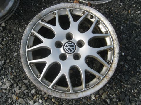 1993 Ford Probe - A single silver Volkswagen alloy wheel with a BBS logo is shown, resting on a gravel surface.