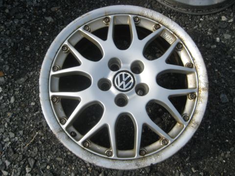 1993 Ford Probe - A single silver BBS wheel with the Volkswagen logo is shown, likely for sale.