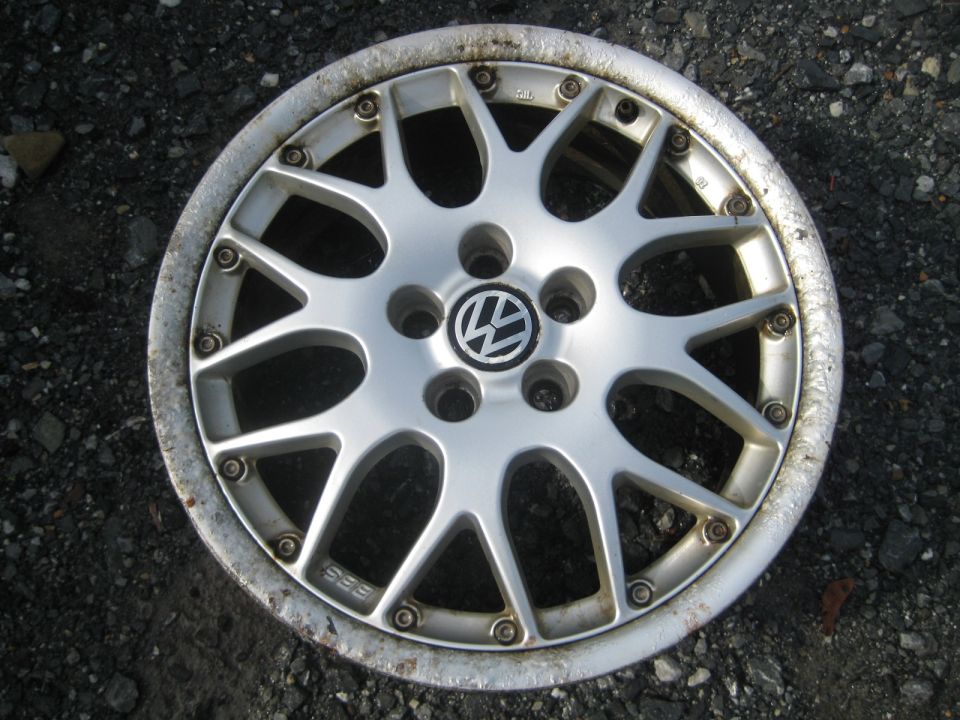 Silver BBS alloy wheel with Volkswagen logo center cap. Shows "BBS" text on spokes