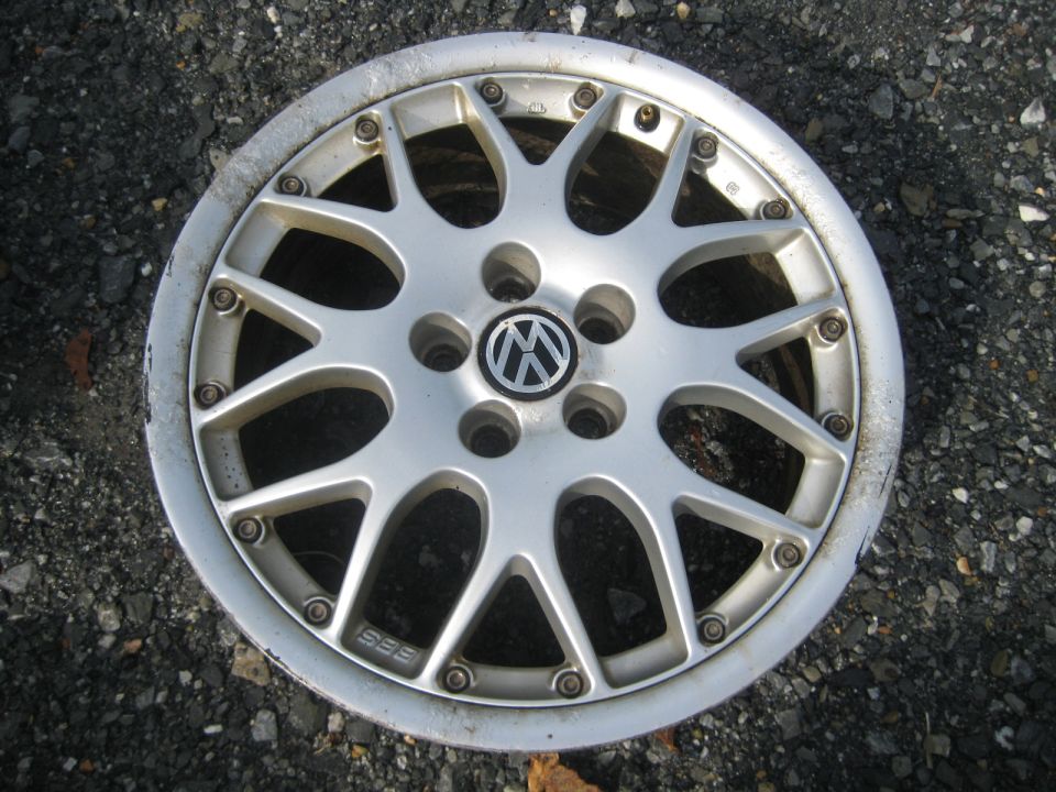 Silver BBS alloy wheel with Volkswagen logo in center. Shows some wear around the rim