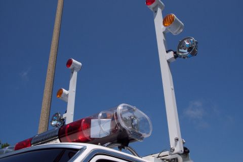 2001 Ford Crown Victoria - Close-up of a 2001 Ford Crown Victoria's emergency light bar against a clear blue sky.