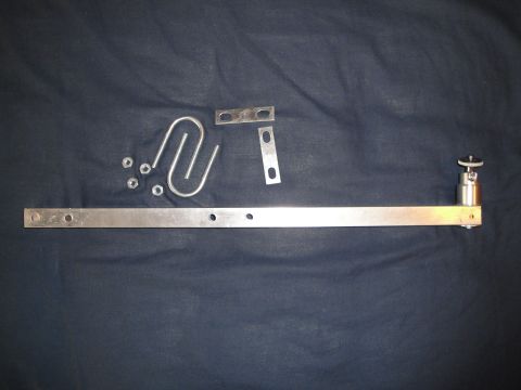1993 Ford Taurus - Various metal parts, including a long bar, a U-shaped piece, nuts, and small plates, are laid out on a dark fabric surface.