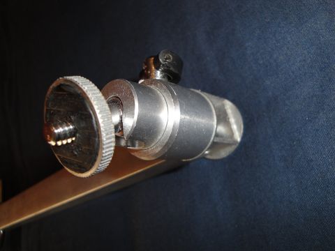 1993 Ford Taurus - A close-up view of a metal clamp with adjustable components against a dark fabric background.