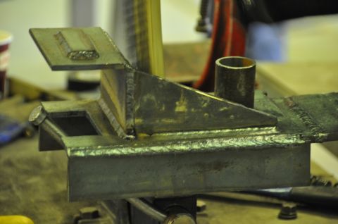 1996 Ford Bronco - A close-up view of a custom-fabricated metal bracket, likely a component for a larger assembly or vehicle.