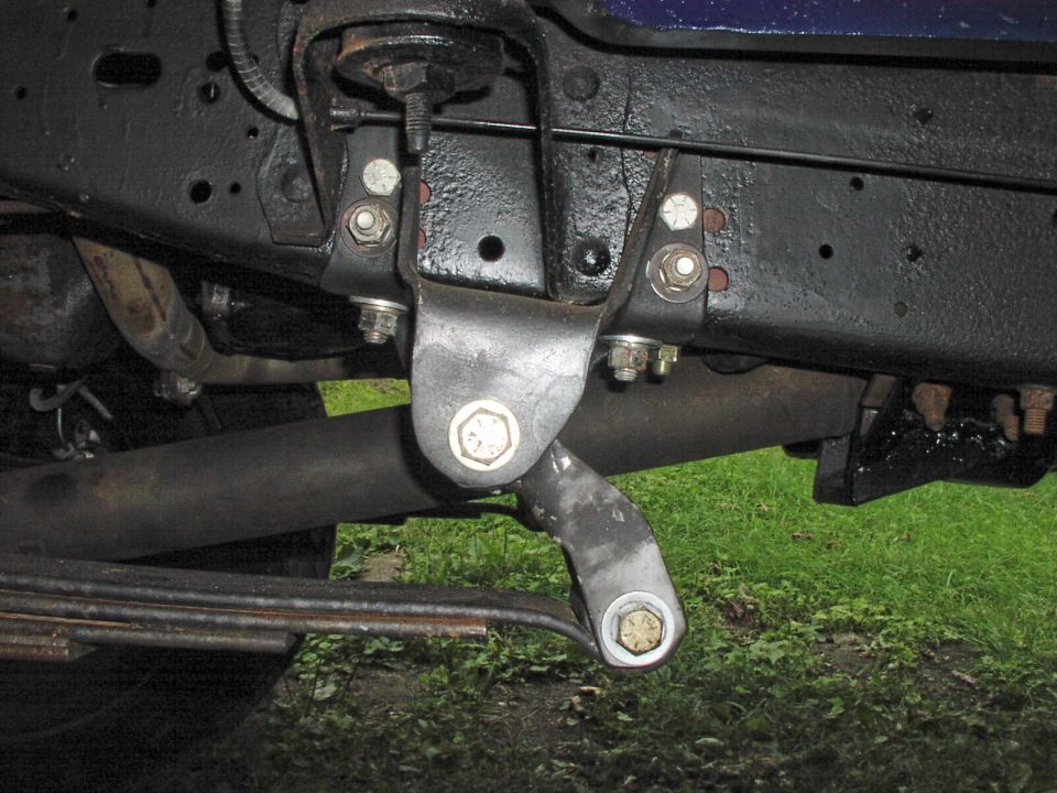 Close-up of vehicle suspension components and leaf springs
