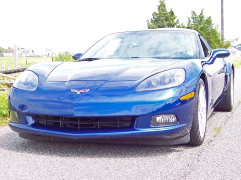 2006 Chevrolet Corvette - Front view of a blue Chevrolet Corvette, likely a 2005 model, not a Z06 bumper as claimed.