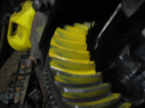 1995 Ford Bronco - Close-up view of differential gears, painted yellow, with a yellow container visible.