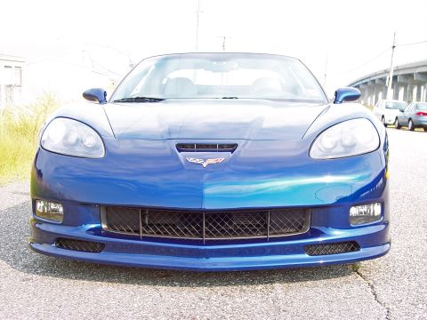 2006 Chevrolet Corvette - Front view of a blue Chevrolet Corvette, showing its distinctive grille and emblem.
