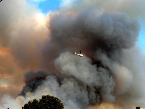 1996 Ford Bronco - A helicopter navigates through thick smoke billowing from a fire.