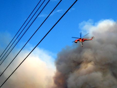 1996 Ford Bronco - A red helicopter navigates through heavy smoke, likely responding to a fire.