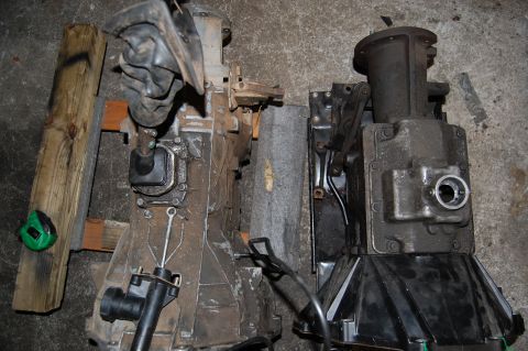 1994 Ford Bronco - Two vehicle transmissions are shown, one on the left with a shifter and boot, and another on the right.