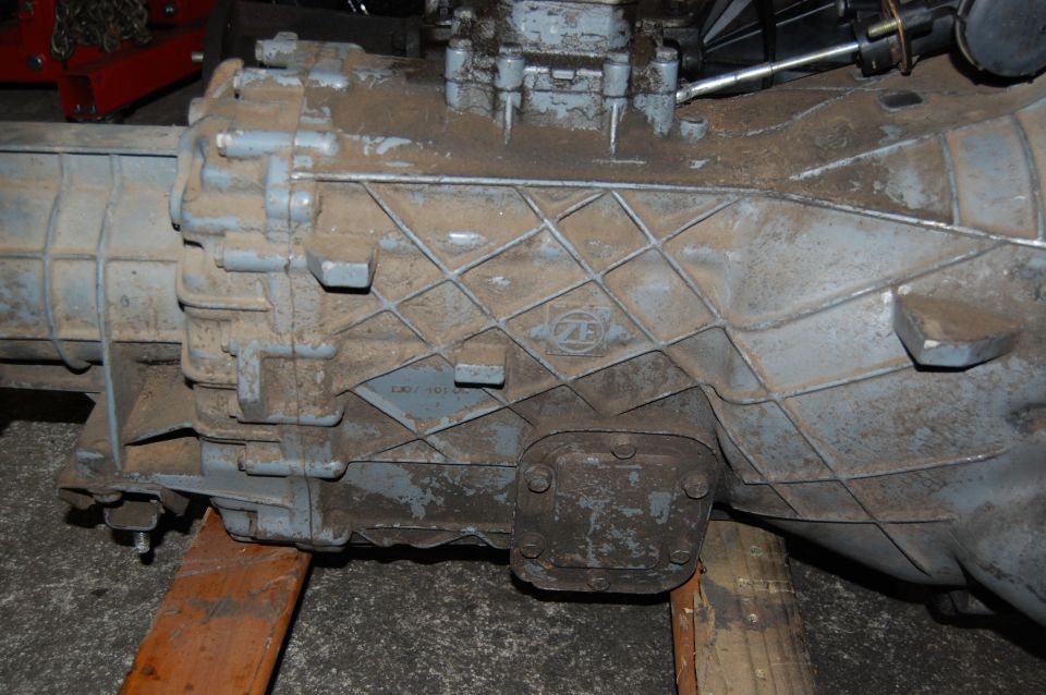Gray transmission with ZF logo, supported by wooden blocks